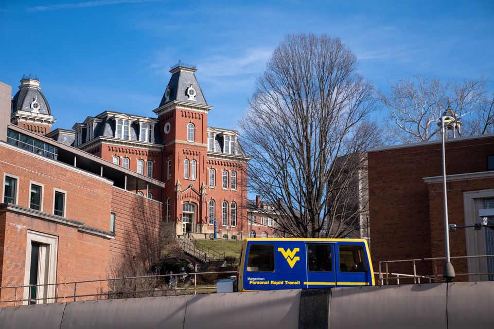 A PRT car approaches the Beechurst station below Woodburn hall on a sunny winter afternoon on the downtown campus